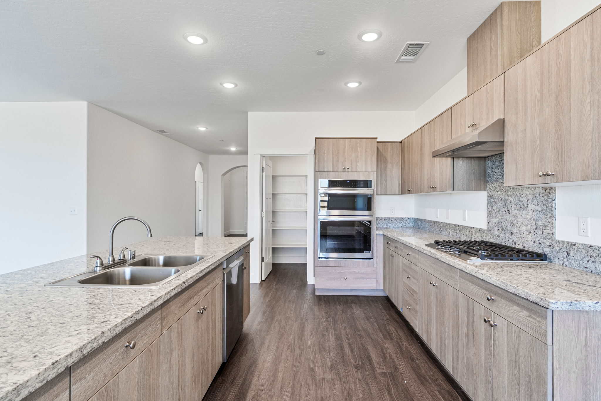 Modern kitchen with light wood cabinets and granite countertops for a stylish look.