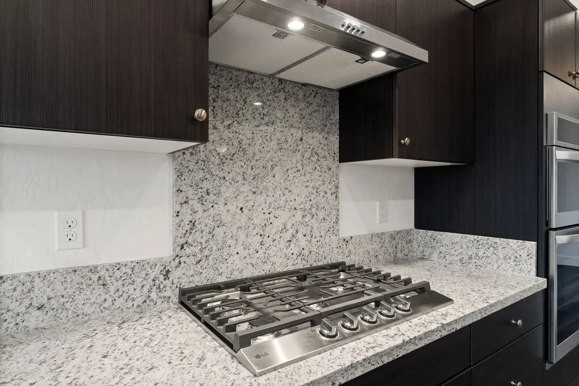 Kitchen with granite countertops and built-in gas stove.
