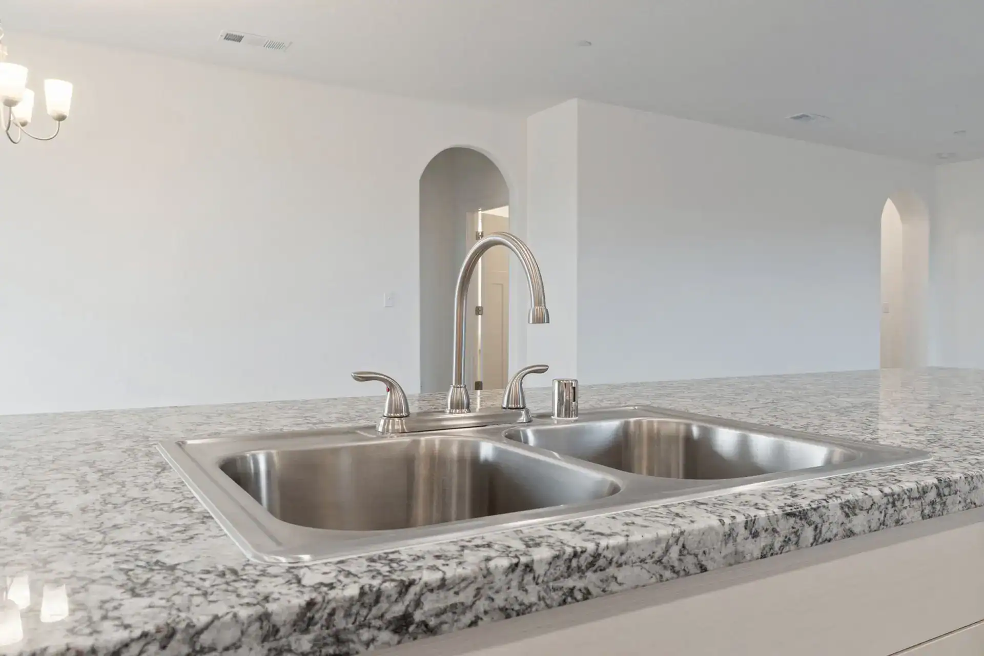Modern kitchen sink with granite countertop and stainless steel fixtures for a sleek look.
